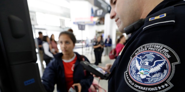 U.S. Customs and Border Protection officer Julio Corro, right, helps a passenger navigate one of the new facial recognition kiosks at a United Airlines gate before boarding a flight to Tokyo, Wednesday, July 12, 2017, at George Bush Intercontinental Airport, in Houston. The Trump administration intends to require that American citizens boarding international flights submit to face scans, something Congress has not explicitly approved and privacy advocates consider an ill-advised step toward a surveillance state. (AP Photo/David J. Phillip)