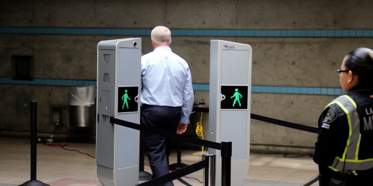 Chris McLaughlin, a vice president with Evolv Technology, test the company's body scanner at Union Station subway station in Los Angeles Wednesday, Aug. 16, 2017. Passengers boarding subway trains in Los Angeles may soon be shuffled through airport-style body scanners that are aimed to detect firearms and explosives. A two-day pilot program by the Los Angeles Metropolitan Transportation Authority, Metro began Wednesday at Union Station. Officials say the machines can scan about 600 people per hour. (AP Photo/Mike Balsamo)
