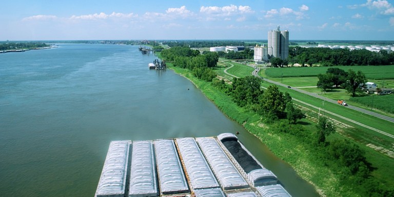 Barges carry coal along the Mississippi River, on the banks of Ascension Parish. This area, along the Mississippi between Baton Rouge and New Orleans, is widely known as "cancer alley" as it is so burdened with polluting industry.