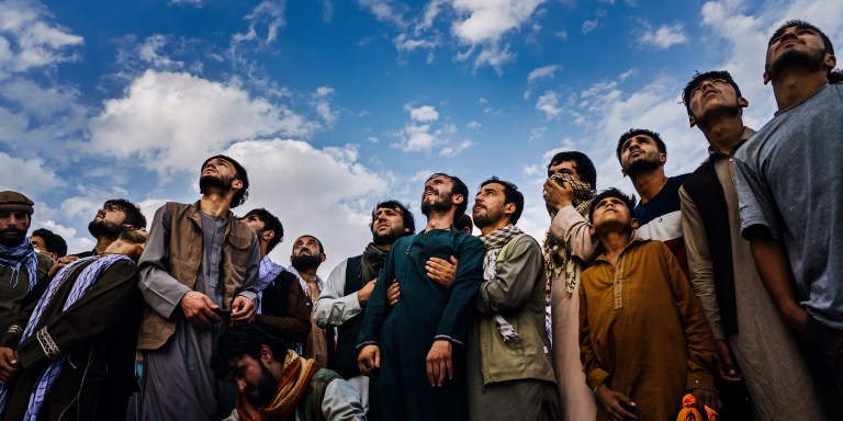 Mourners at a mass funeral look up and weep as the roar of jet engines drown out their wails in Kabul, Afghanistan, on Aug. 30, 2021. Fighter jets circled the hilltop cemetery where members of the Ahmadi family were burying 10 of their own - seven of them children - all victims of a U.S. drone strike. A full day before the U.S. military withdrawal approached its conclusion, death continued to haunt the war-torn country. The airstrike came in the wake of an airport bombing on Aug. 26 carried out by ISIS-K militants. The United States military claimed initially that it was targeting an alleged Islamic extremist who posed the threat of carrying out a similar attack. A month later, it reversed its position, but the Pentagon decided no American troops would be punished. Left to grieve and wonder, Emal Ahmadi could not understand how it could be that a family could die and no one be held accountable.