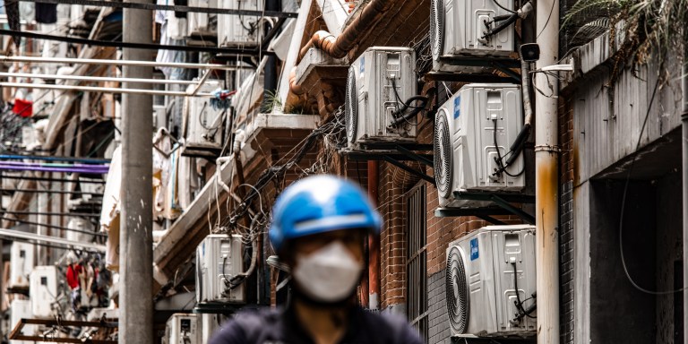 Air conditioner units at a building in Shanghai, China, on Friday, June 23, 2023. Extreme weather is already promising a fresh test of the electricity grid just months after heat waves and drought throttled hydropower and triggered widespread power shortages. Photographer: Qilai Shen/Bloomberg via Getty Images