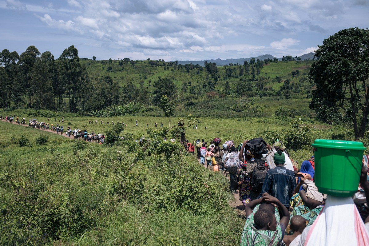 Residents of Bambo in Rutshuru territory, 60 kilometers north of Goma, the capital of North Kivu, eastern Democratic Republic of Congo, flee as the M23 attacked the town on October 26, 2023. Around noon, M23 rebels, supported by the Rwandan army according to the UN, the USA and the European Union, attacked the town of Bambo with mortars, causing several thousand inhabitants to flee. Hundreds of Congolese soldiers, police officers and proxy militiamen were seen joining the population as they tried to escape the fighting. Several civilians were killed and wounded in the fighting, according to medical sources on the spot. The M23 has captured swathes of territory in North Kivu province since 2021, forcing more than a million people to flee. (Photo by ALEXIS HUGUET / AFP) (Photo by ALEXIS HUGUET/AFP via Getty Images)