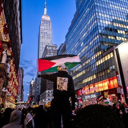 NEW YORK, UNITED STATES - 2023/11/09: A protester waves a Palestinian flag as others march past during a student walkout calling for a ceasefire between Israel and Hamas. Since October 7, the Israeli army's bombardment of the Palestinian enclave, in retaliation for the Hamas attack on Israel that killed over 1,400 people, has seen thousands of buildings razed to the ground, more than 10,000 people killed and 1.4 million displaced whilst Gaza remains besieged. (Photo by Michael Nigro/Pacific Press/LightRocket via Getty Images)