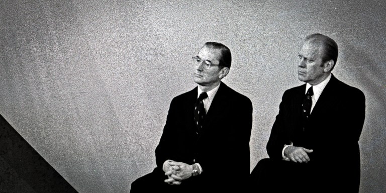 Incoming Central Intelligence Agency (CIA) Director (and future US President) George HW Bush (left) speaks the agency headquarters following his swearing-in ceremony, Langley, Virginia, January 30, 1976. Seated behind him are, from left, outgoing CIA Director William Colby (1920 - 1996) and US President Gerald R Ford (1913 - 2006). (Photo by Barry Soorenko/CNP/Getty Images)